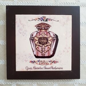 Vintage ceramic tile in a brown wood frame.